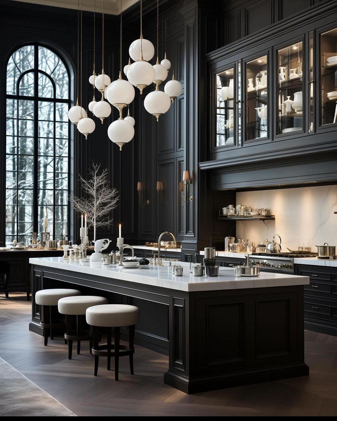 A sophisticated kitchen featuring high ceilings with large arched windows, sleek black cabinetry, and striking white globe pendant lights