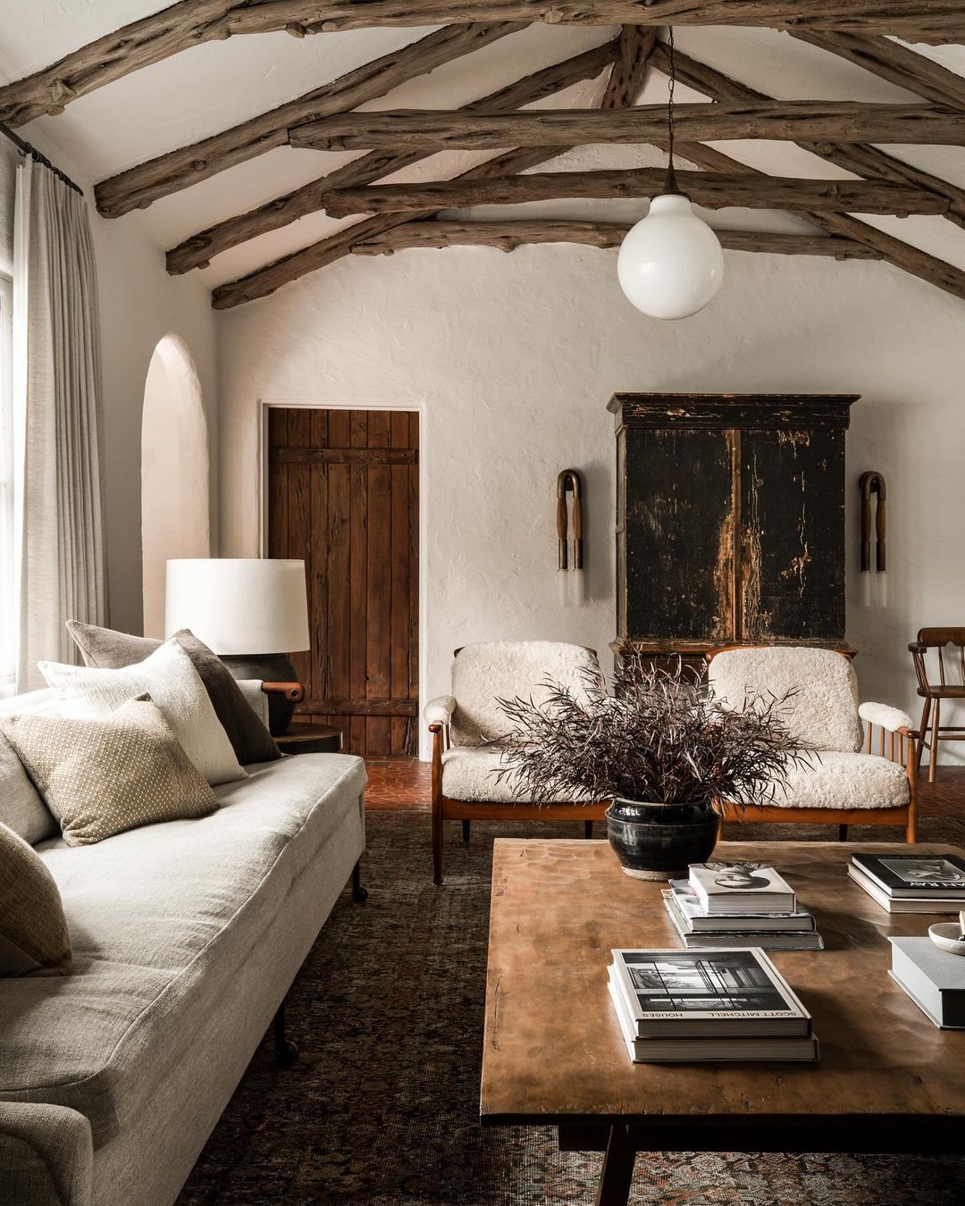 A rustic and stylish living room with exposed wooden beams