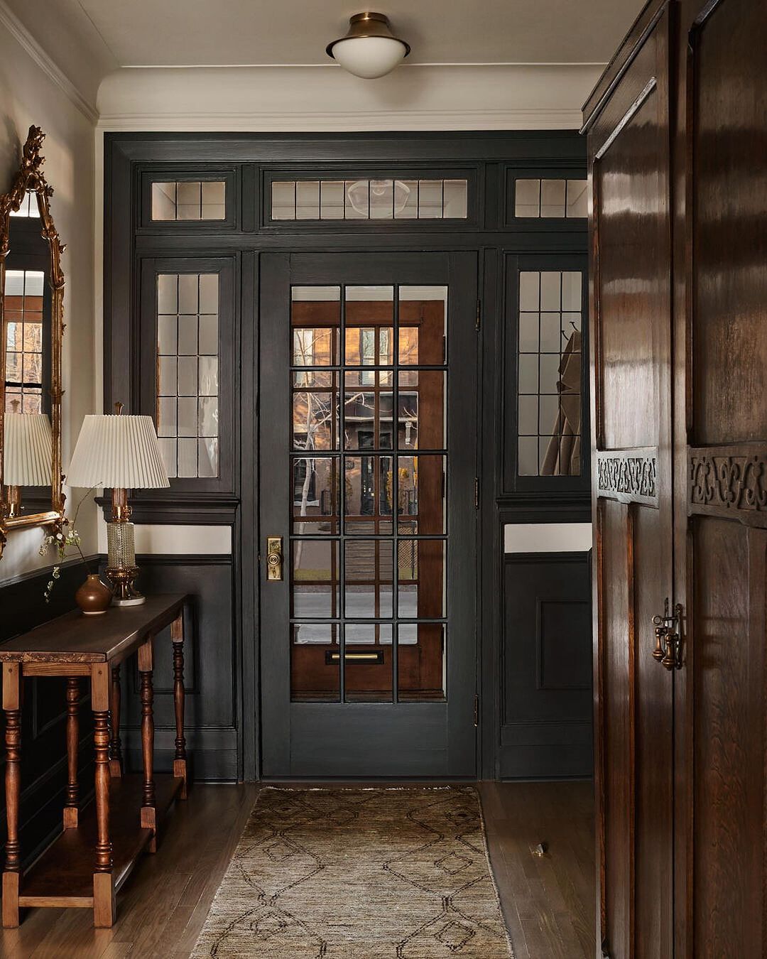 A classic entryway with darkwood tones and glass panels