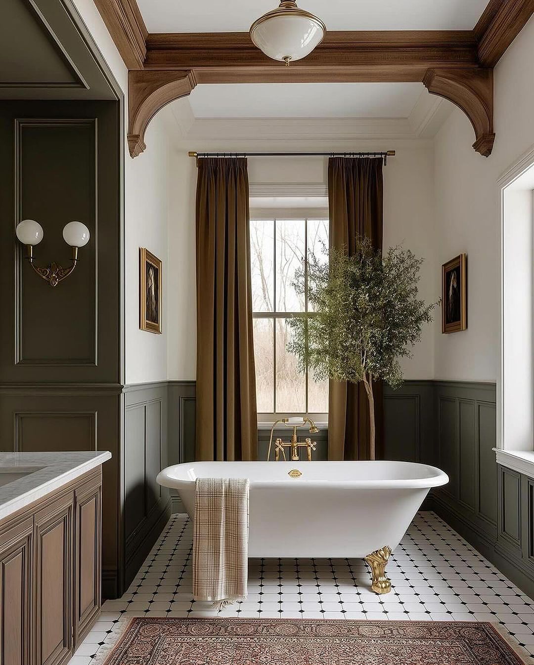 A sophisticated bathroom featuring rich wood trim and deep green wainscoting, with a classic freestanding tub