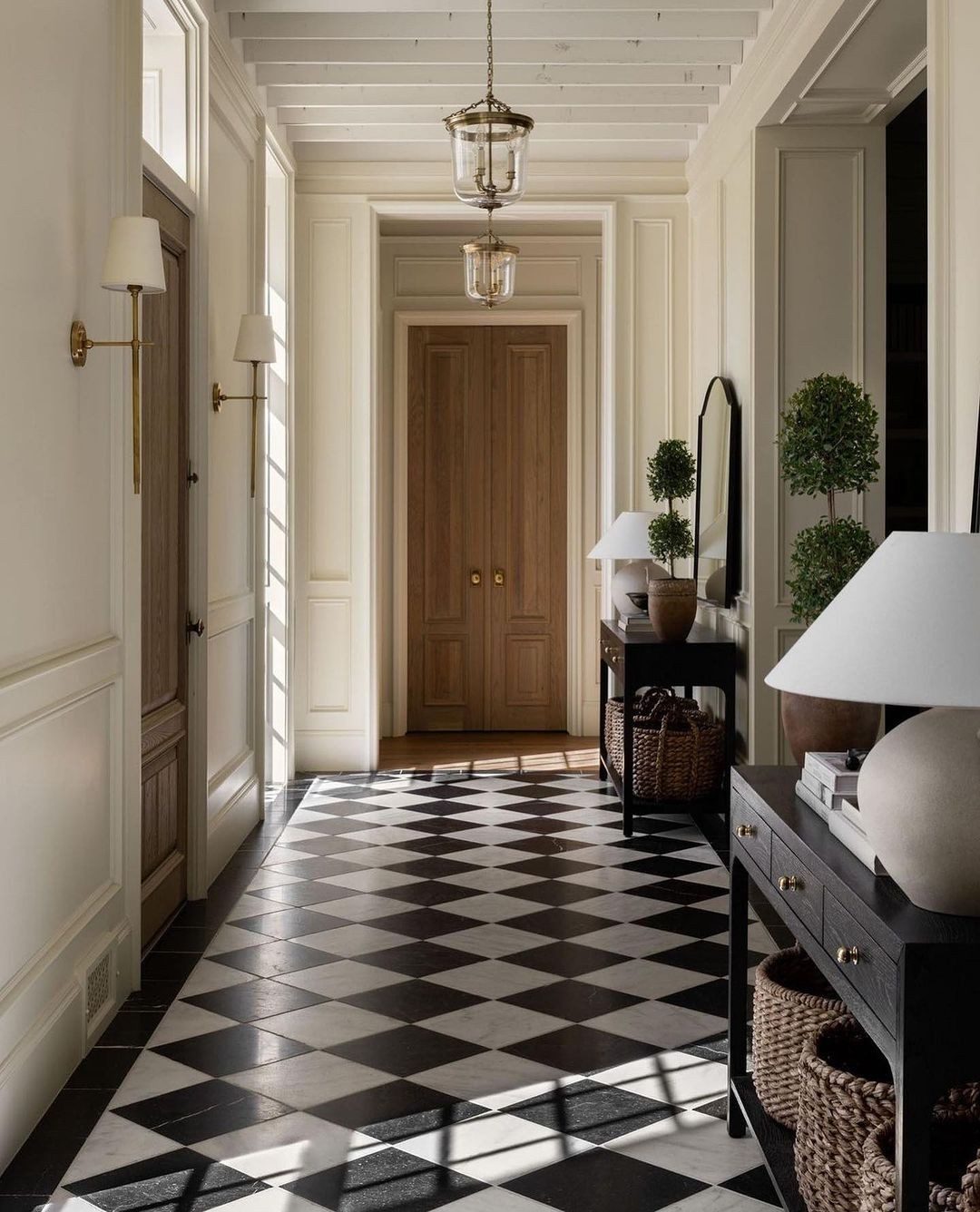 Classic black and white tiled hallway with natural light filtering through