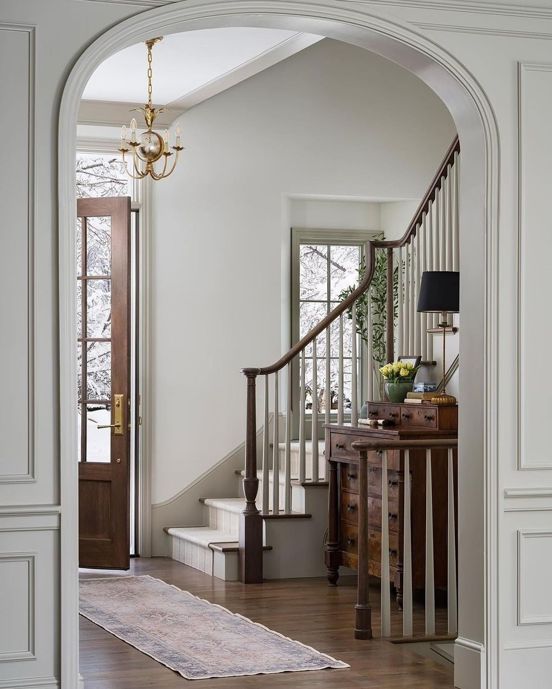 A welcoming entryway with archways and a staircase