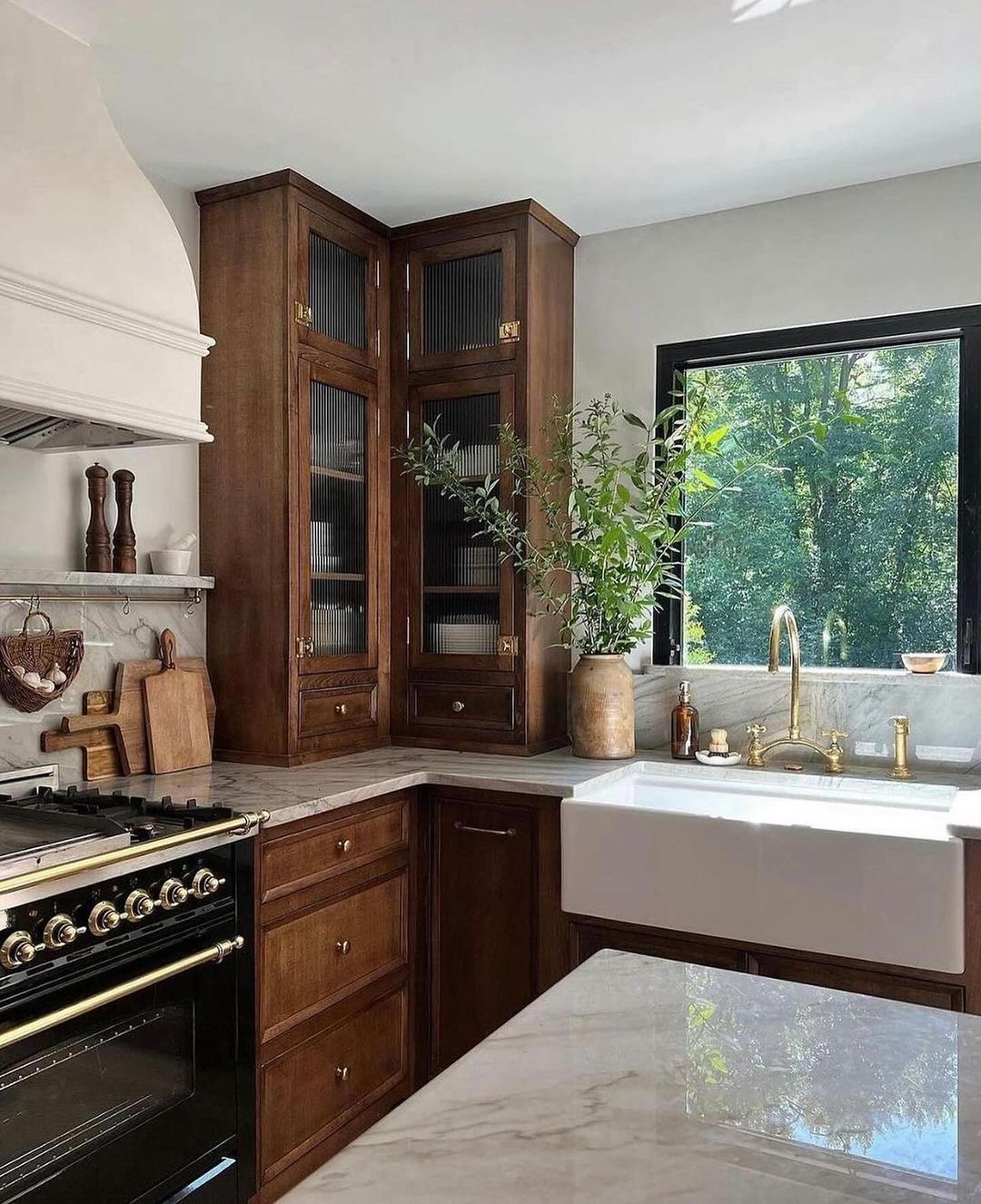 A well-appointed kitchen with rich wood cabinetry and marble countertops