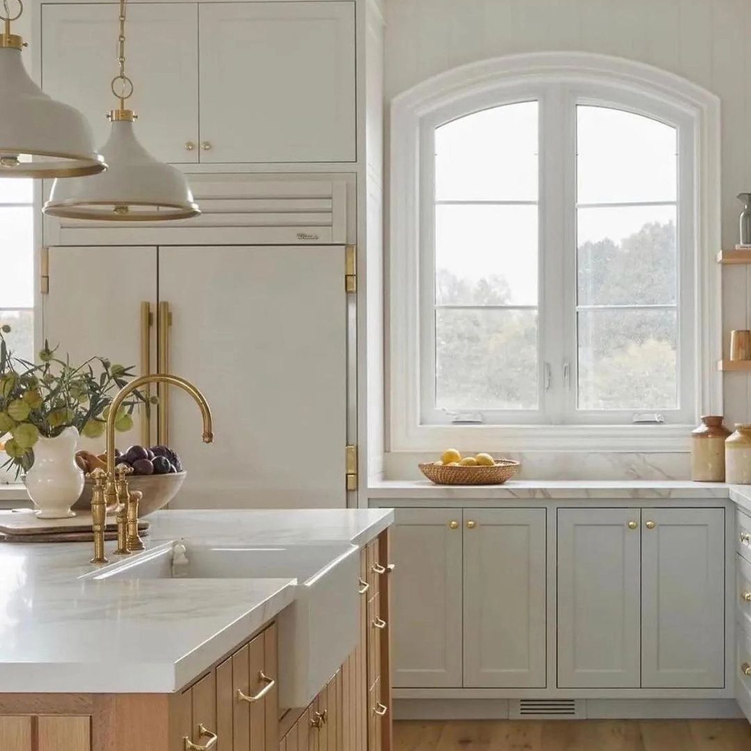 A bright and elegant kitchen with arched windows