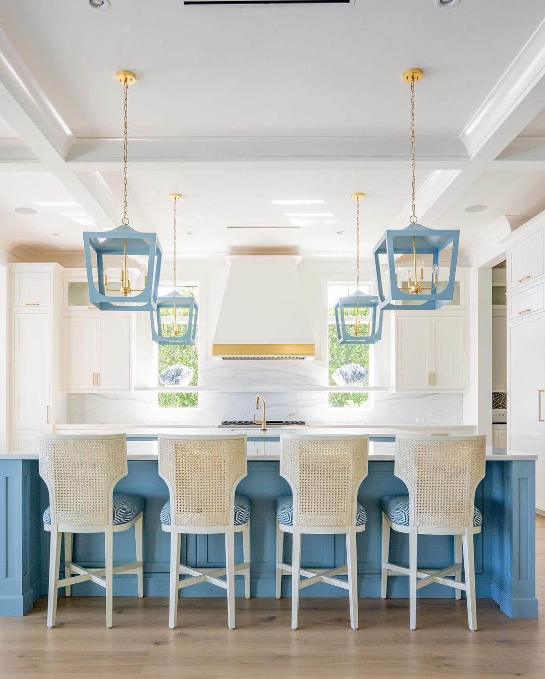 Stylish blue and white kitchen with natural light