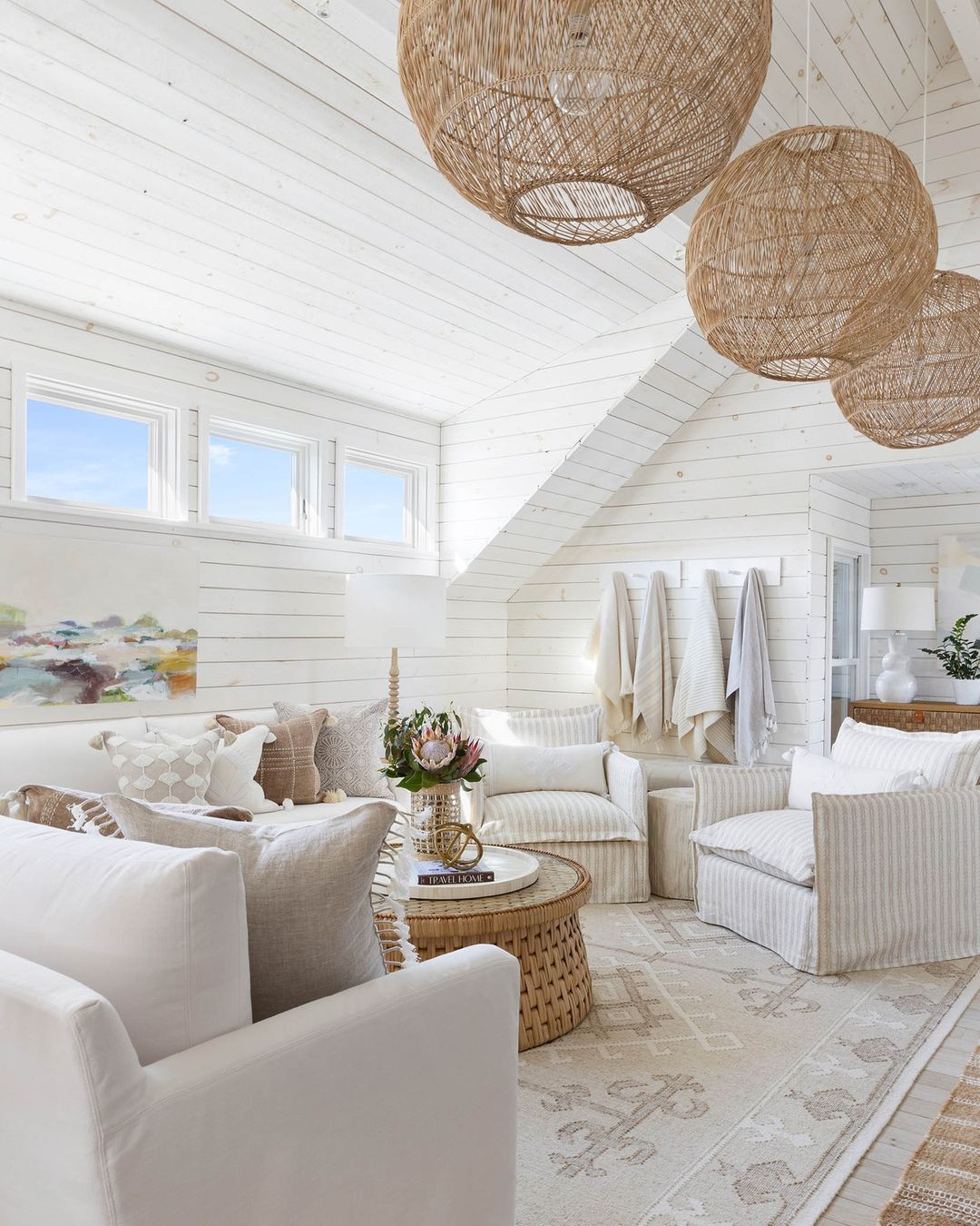 A bright and airy living room with white slipcovered sofas