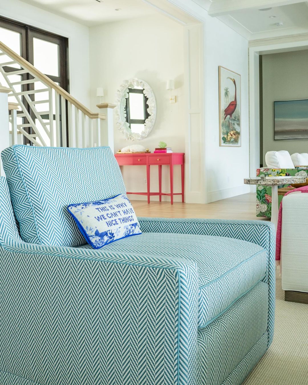 A tastefully designed coastal living room with a chevron-patterned armchair.