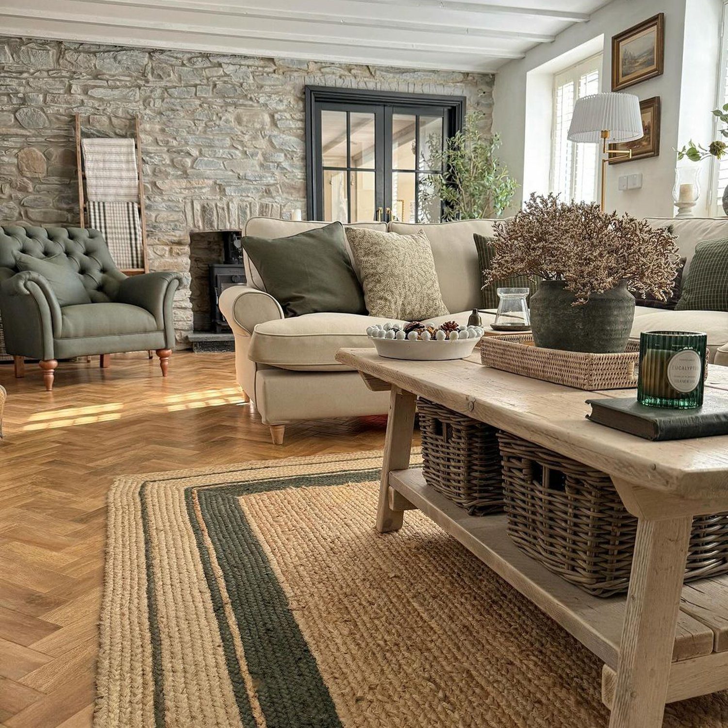 A cozy living room featuring a blend of stone and plush textures