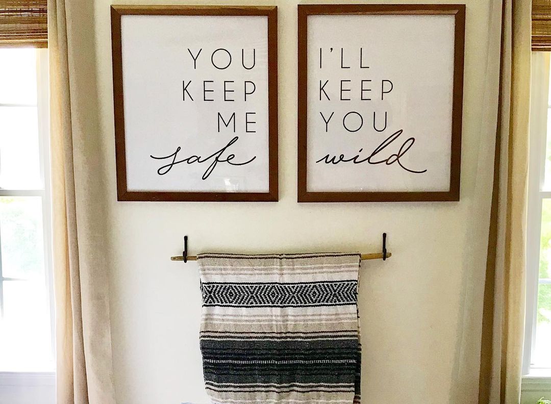 A harmonious wall decor with framed statements: "You keep me safe" and "I’ll keep you wild"