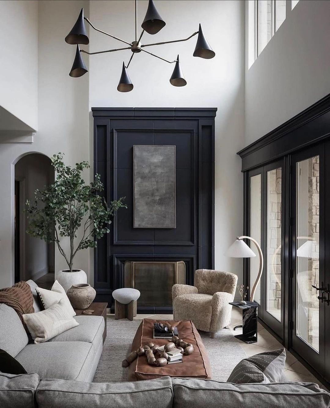 Stylish living room with high ceilings and dark accents