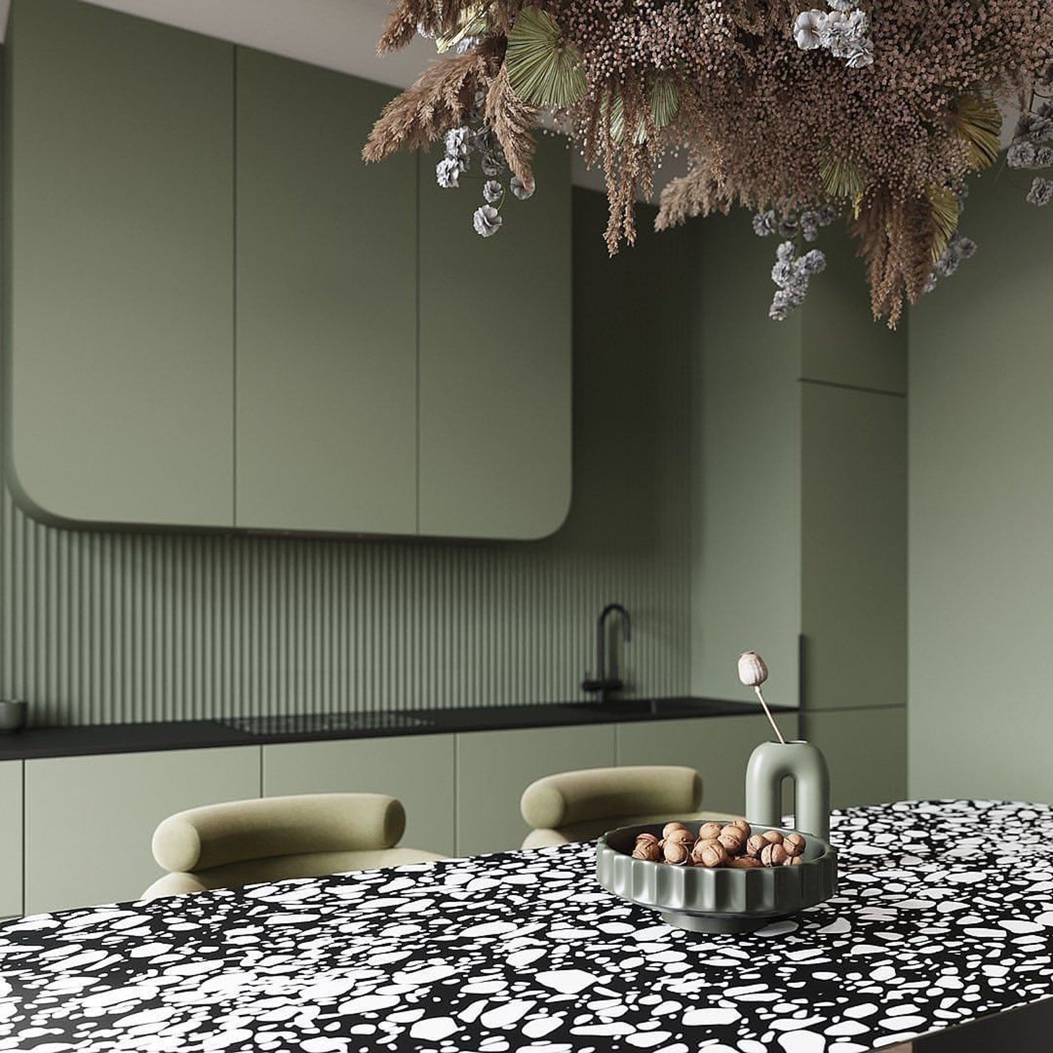 A contemporary terrazzo topped bar with sage green cabinets and minimalist furnishings.