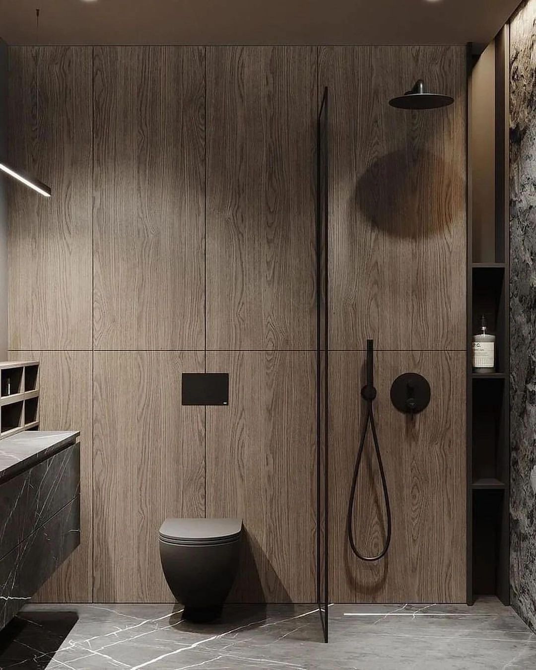 A modern bathroom featuring wood grain cabinetry, sleek black fixtures, and marble flooring