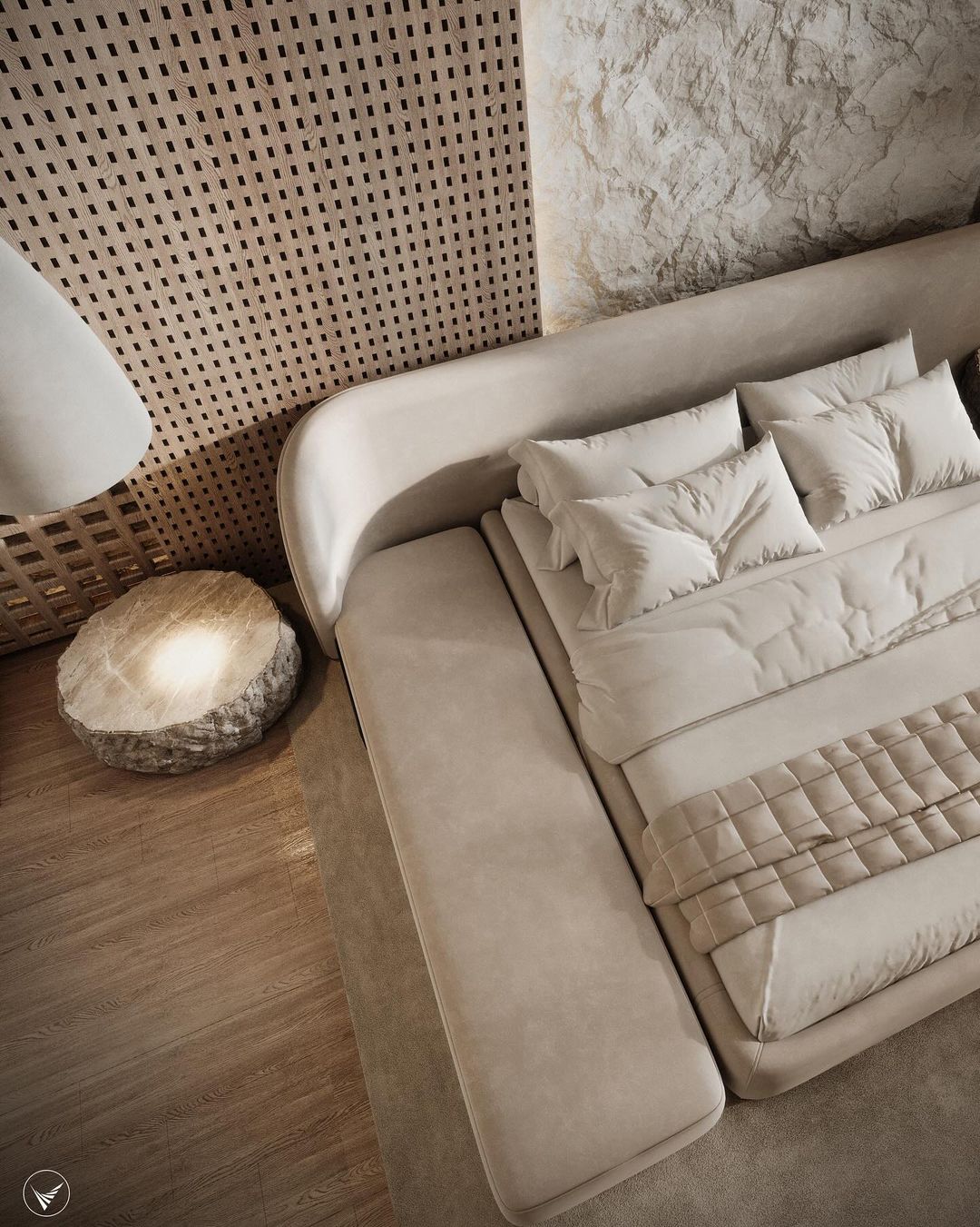 A modern bedroom featuring a plush taupe upholstered bed with padded headboard set against a patterned wooden panel backdrop, paired with a unique rock-shaped bedside lamp.