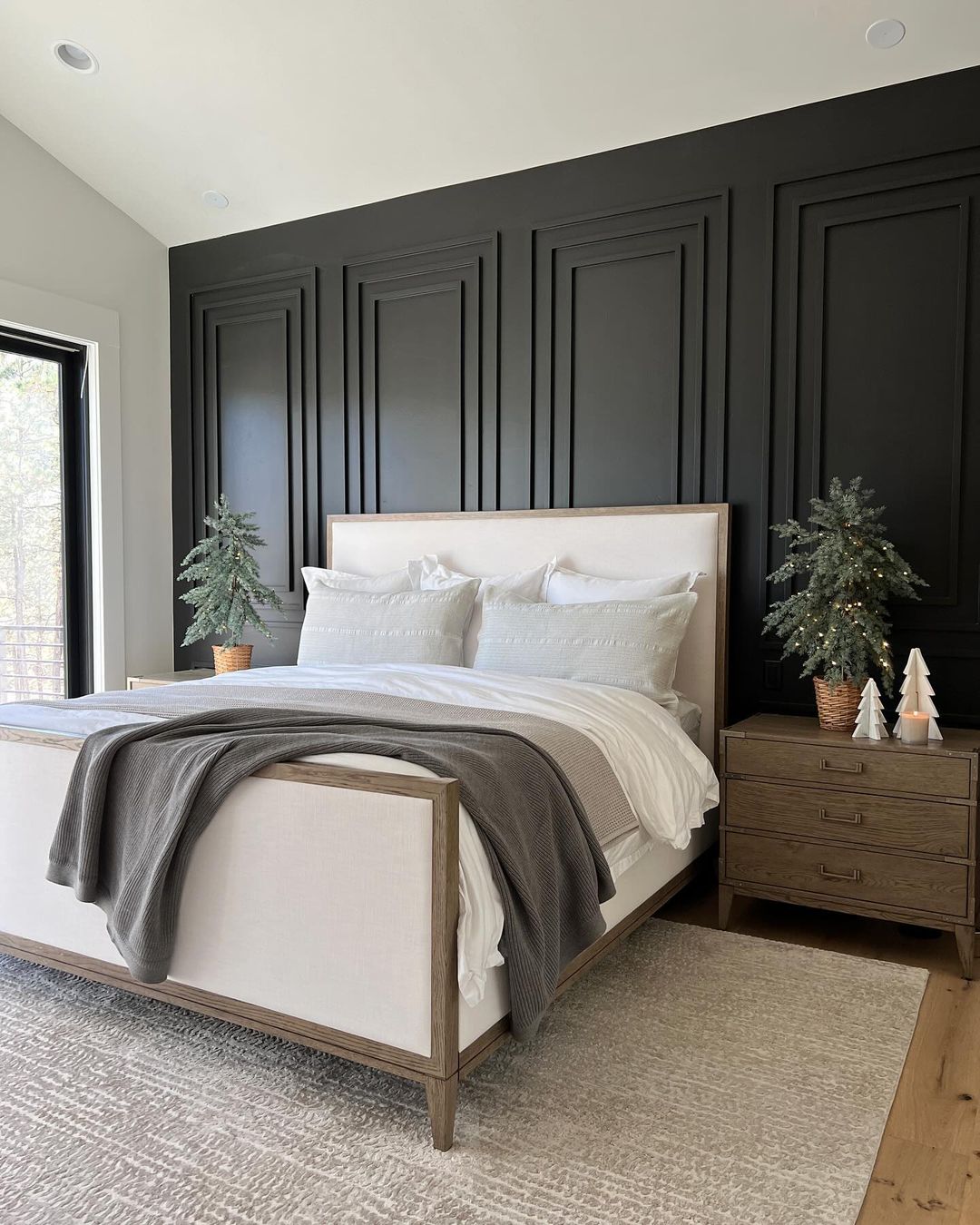 A contemporary bedroom featuring a striking black accent wall