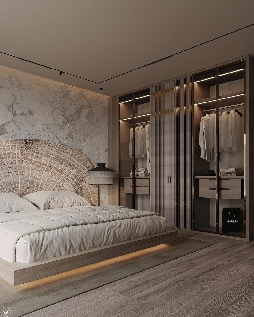 A contemporary bedroom incorporating a wooden bed frame and marble accent wall, with built-in wardrobe lighting.