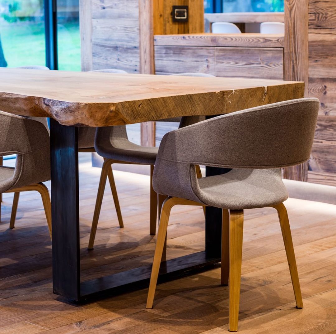 Modern dining area showcasing a natural edge wooden table