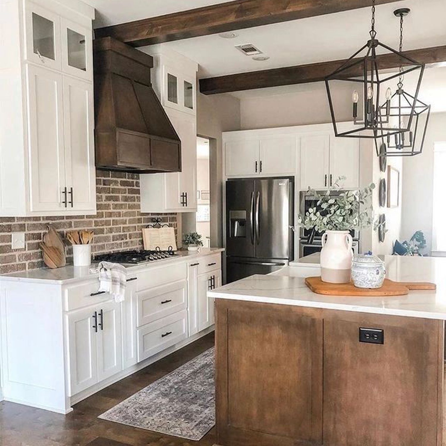 A harmoniously designed kitchen space with warm wood tones and crisp white cabinetry