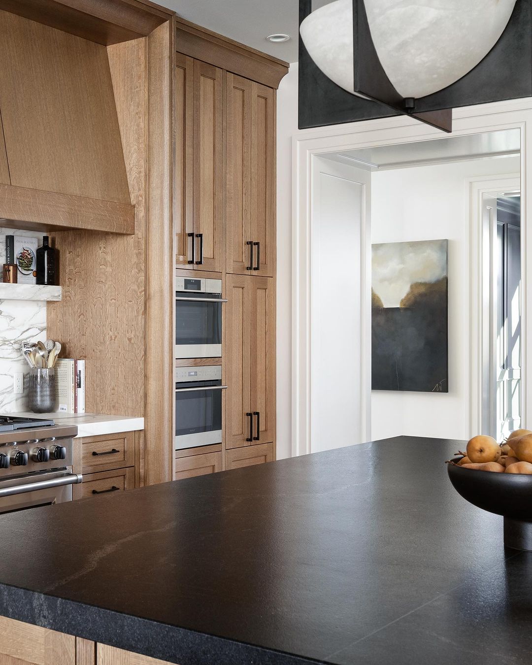 Modern kitchen with dark countertops and wooden cabinetry