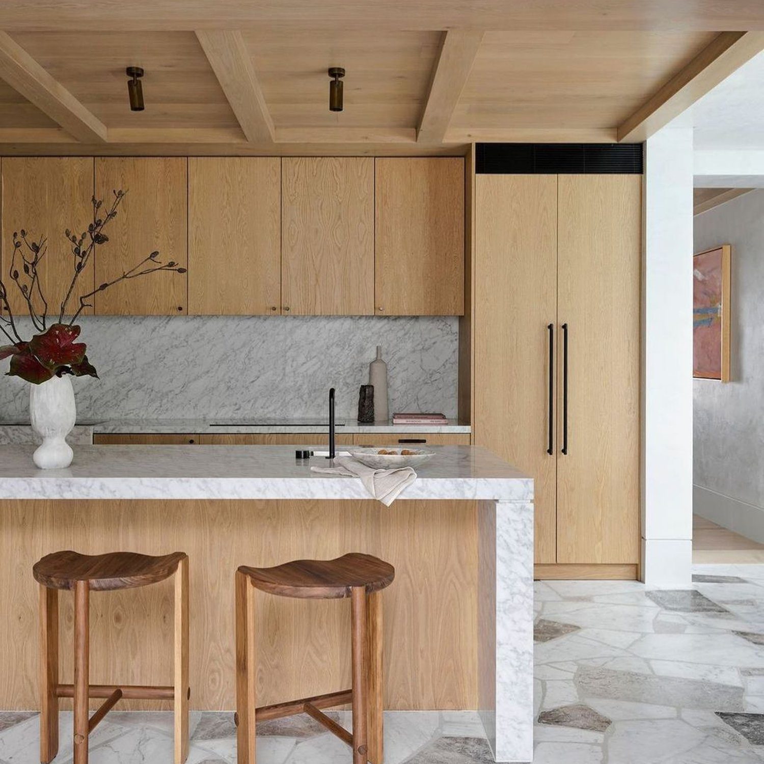 Modern kitchen with natural wood elements and marble countertop