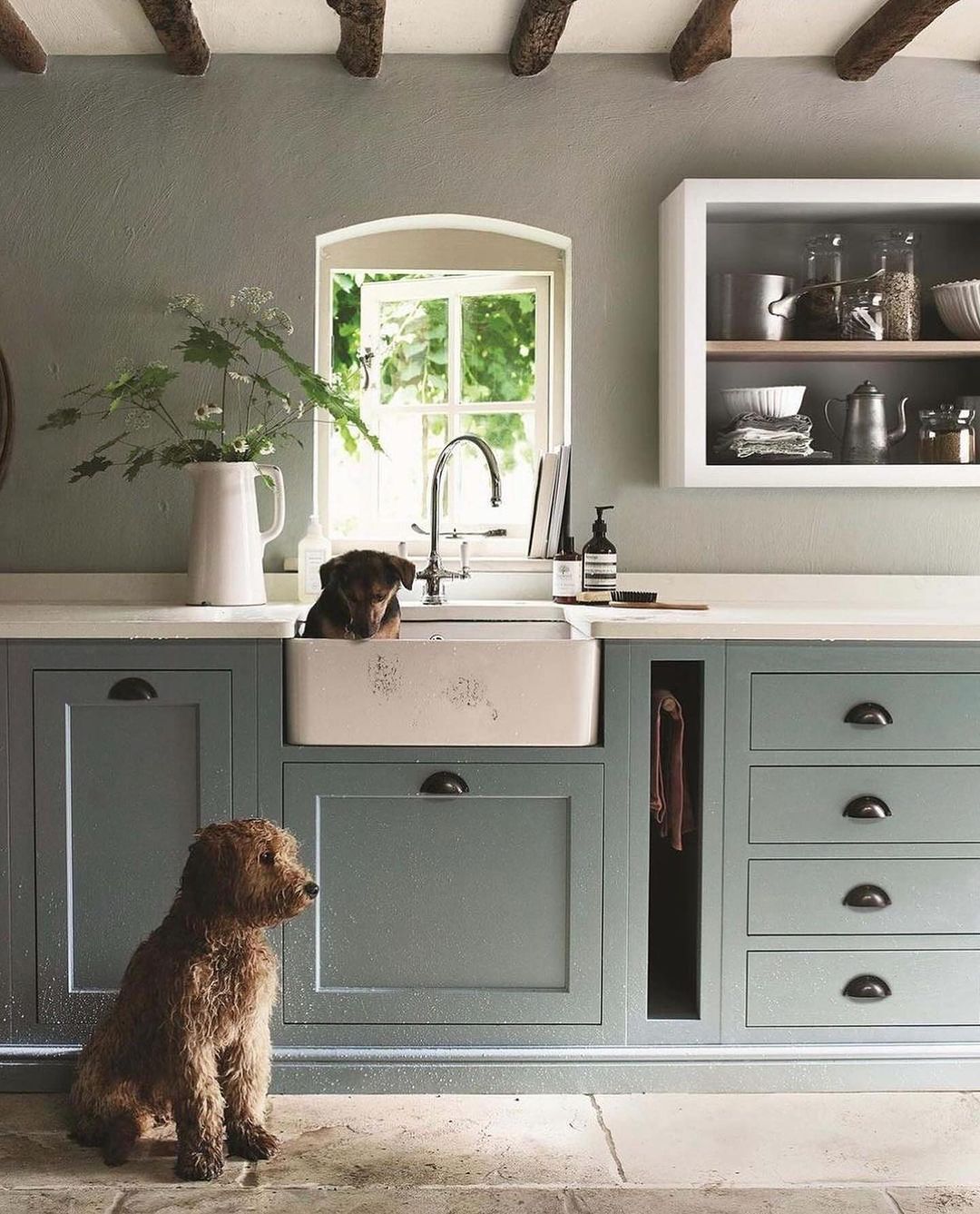 A cozy country-style kitchen with exposed wooden beams and a central island