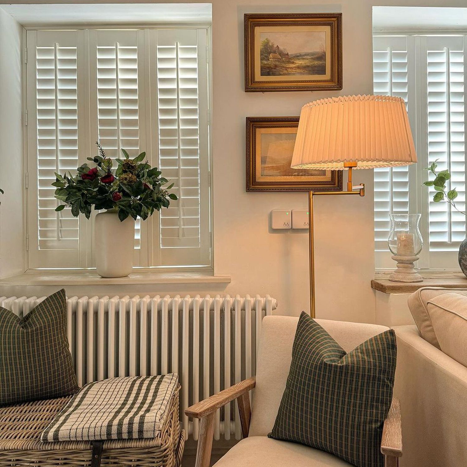 Elegant cozy living room with a classic touch featuring white shutters and plush seating