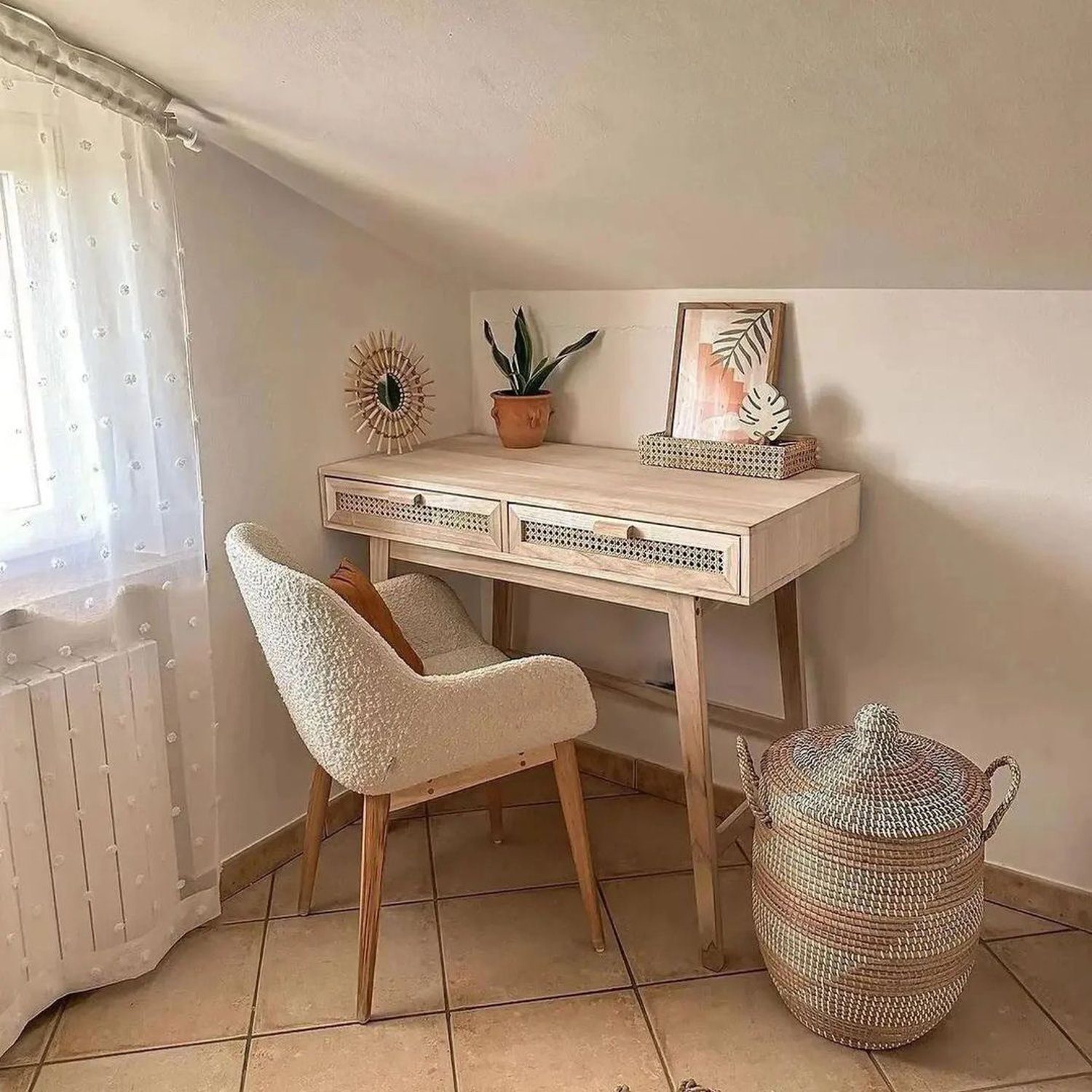 A neatly organized small workspace with a stylish ergonomic chair