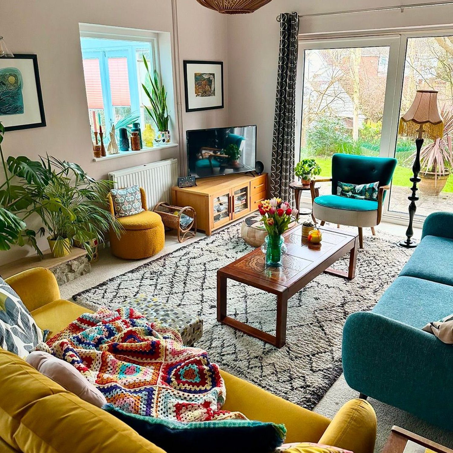 A cozy and vibrant living room with a mix of mid-century modern and eclectic decor.