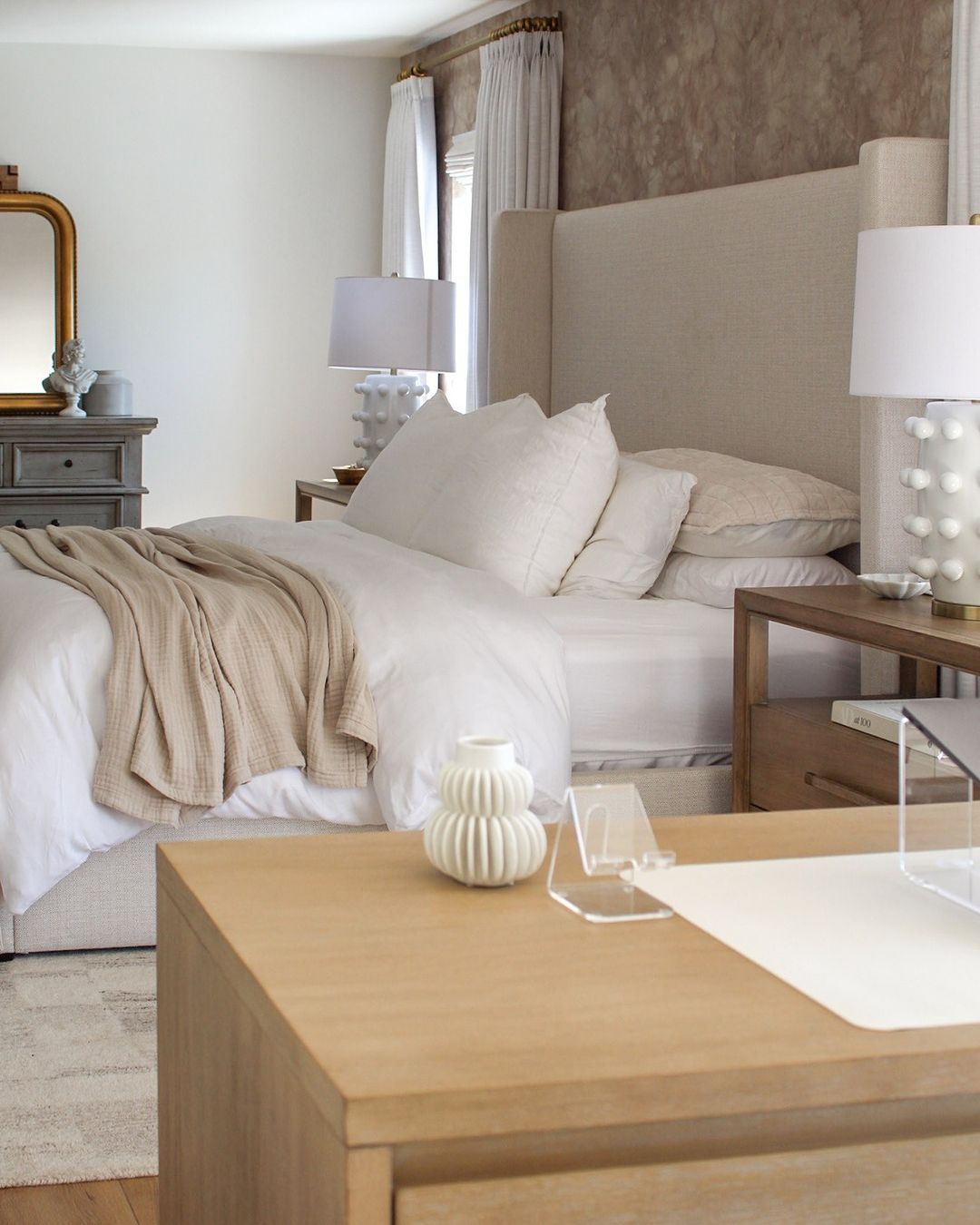 A well-appointed bedroom with a focus on neutral tones and clean lines