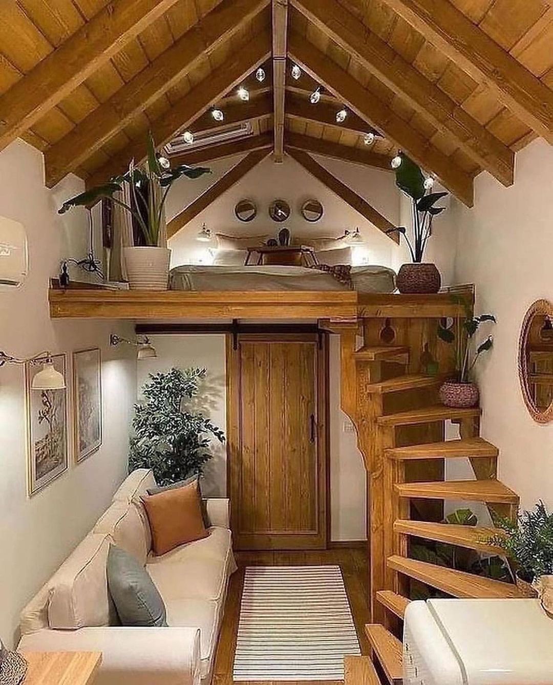 Cozy attic bedroom loft with a wooden ladder access.