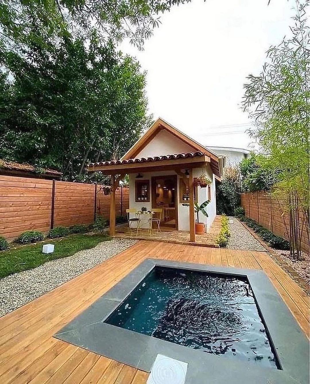 Cozy and compact backyard cottage with a small pool and wooden deck