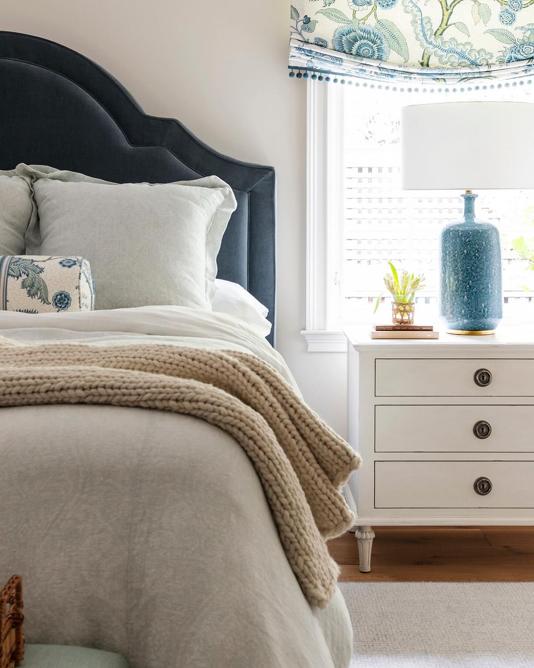 A serene and beautifully styled bedroom with a combination of textures and patterns