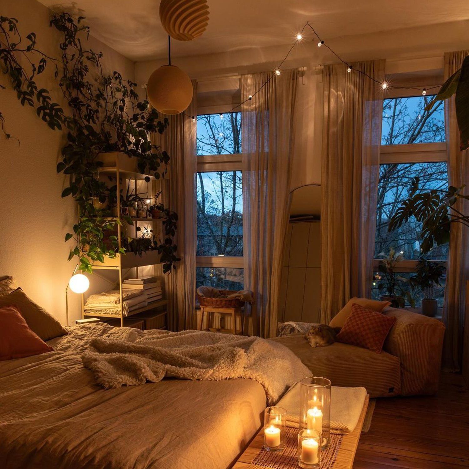 A cozy bedroom with ambient lighting and plants