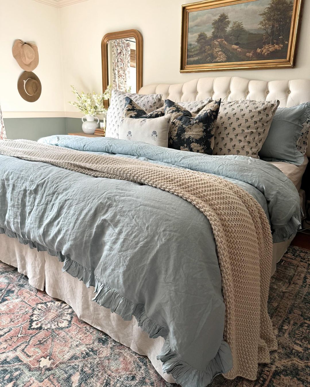 A cozy bedroom setting with tastefully arranged bedding and decor