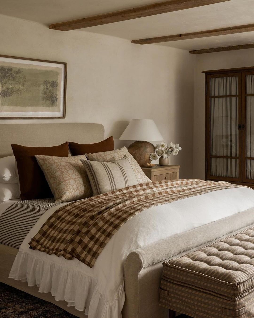 A cozy and inviting bedroom featuring a beige color palette