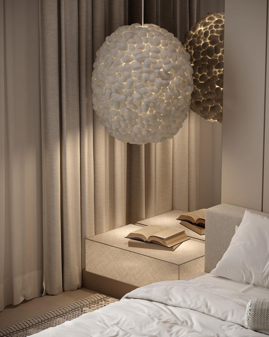 A cozy bedroom corner with a textured beige bench and open books under a unique spherical pendant light