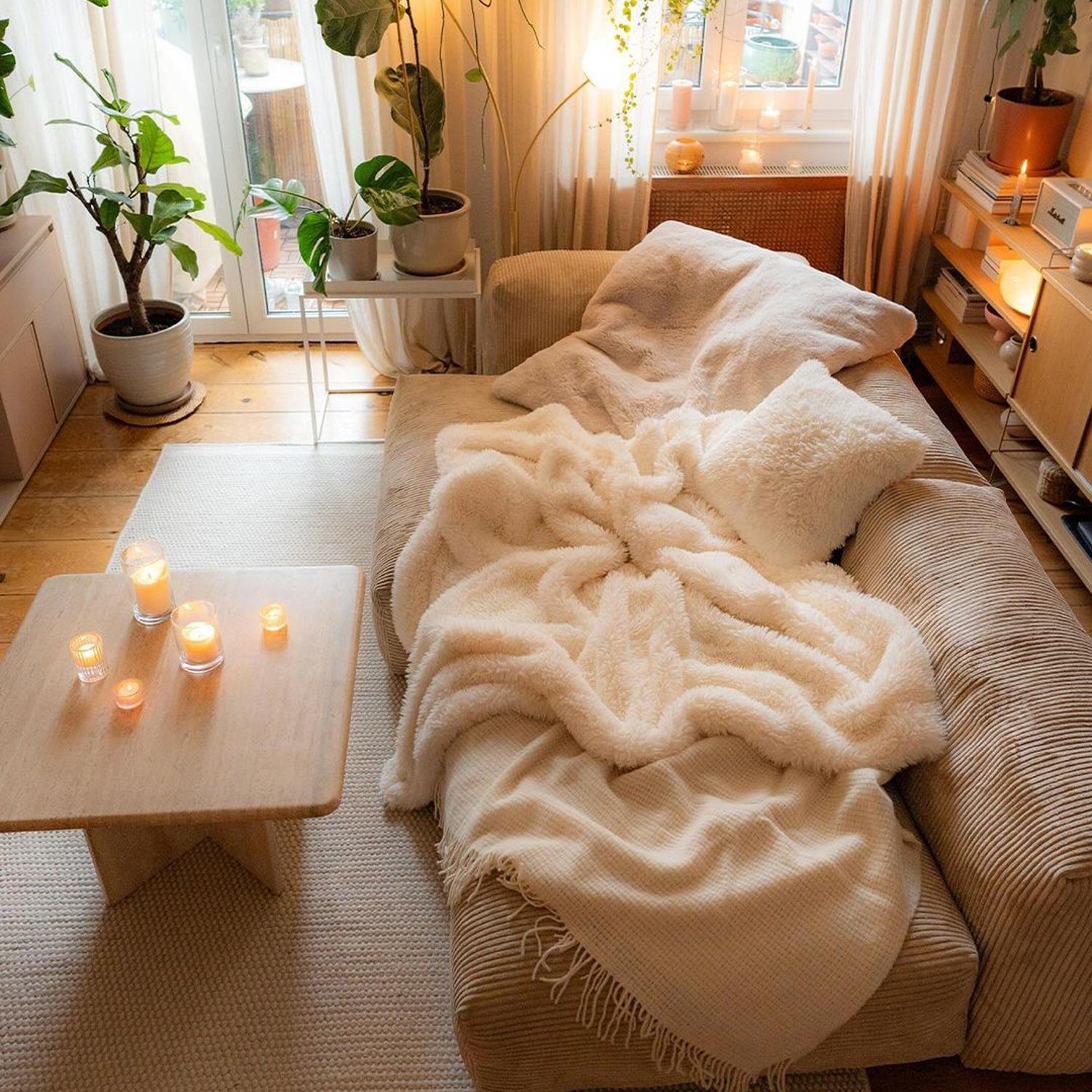 A cozy bedroom nook featuring warm lighting and lush plants