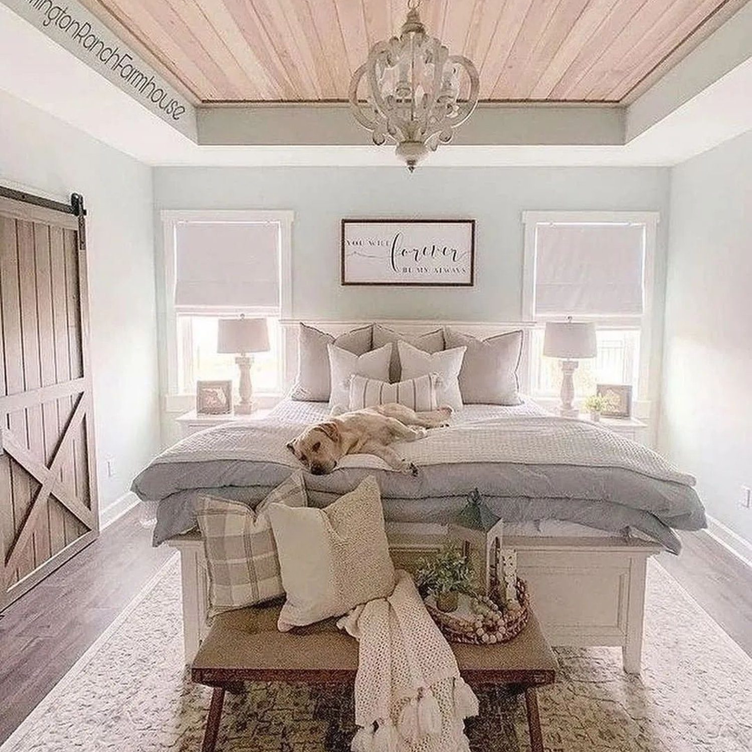 A serene bedroom featuring a comfortable bed with a slumbering dog