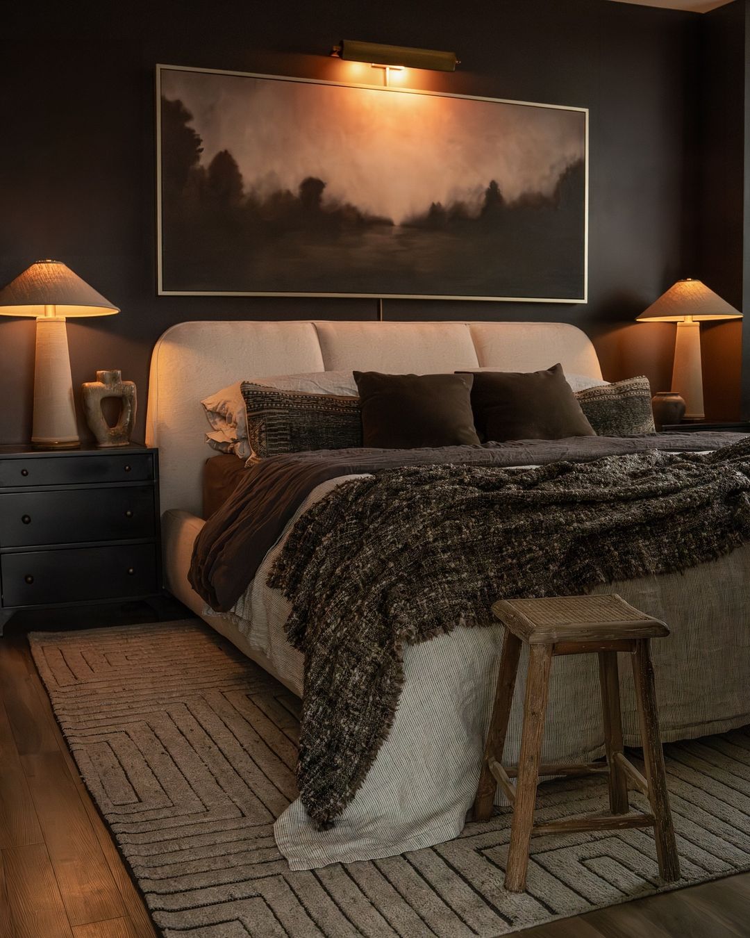 A cozy and chic bedroom featuring dark walls