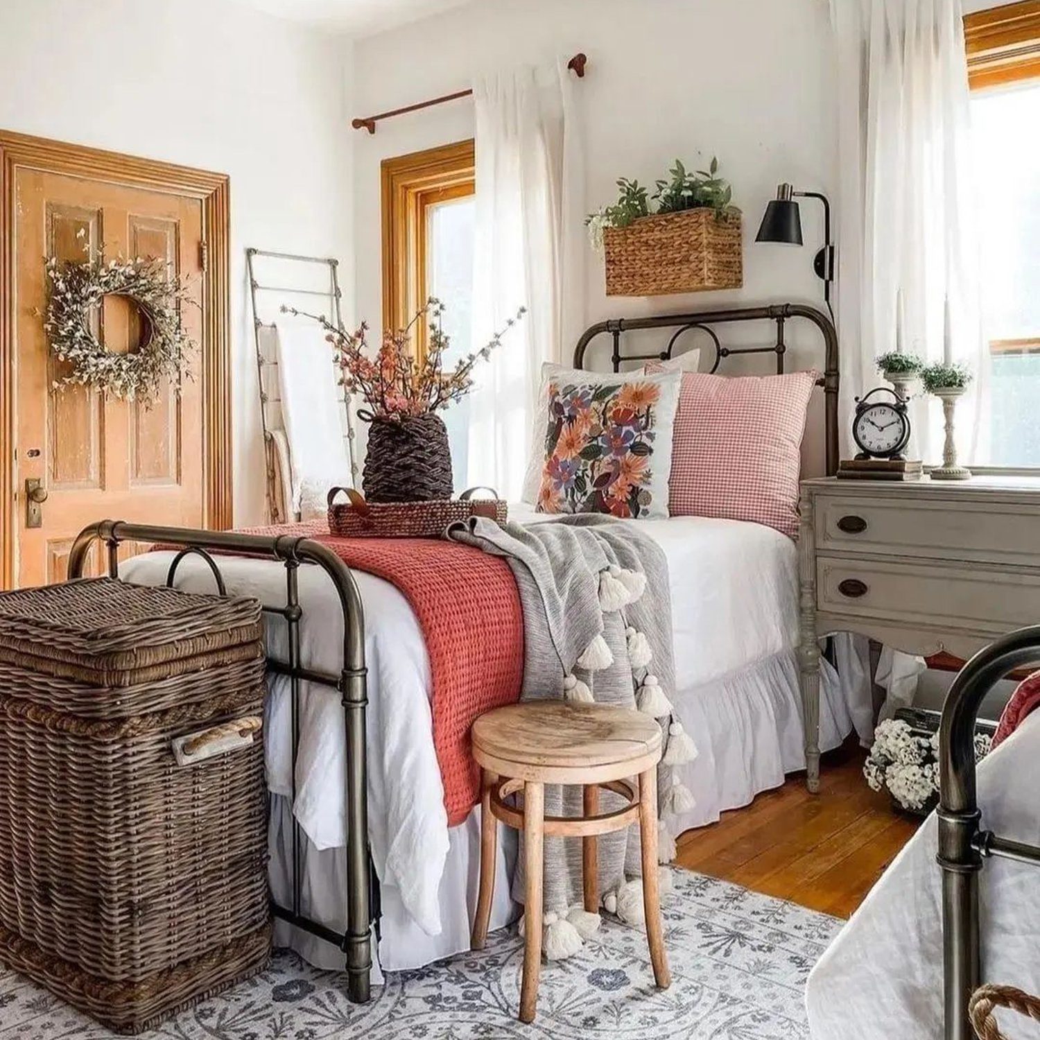 A cozy and inviting bedroom featuring a classic metal frame bed.