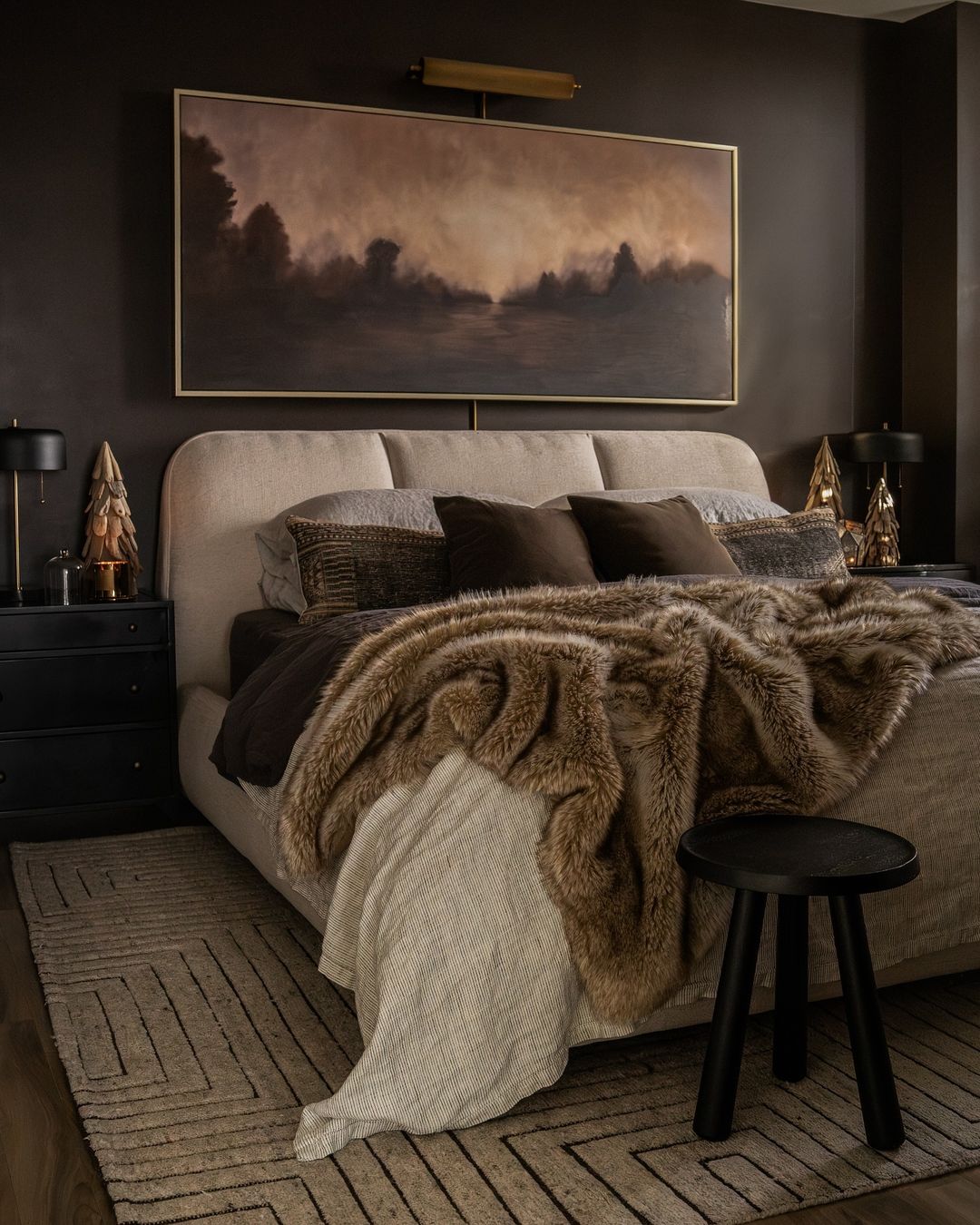 A cozy bedroom with dark walls creating a moody atmosphere