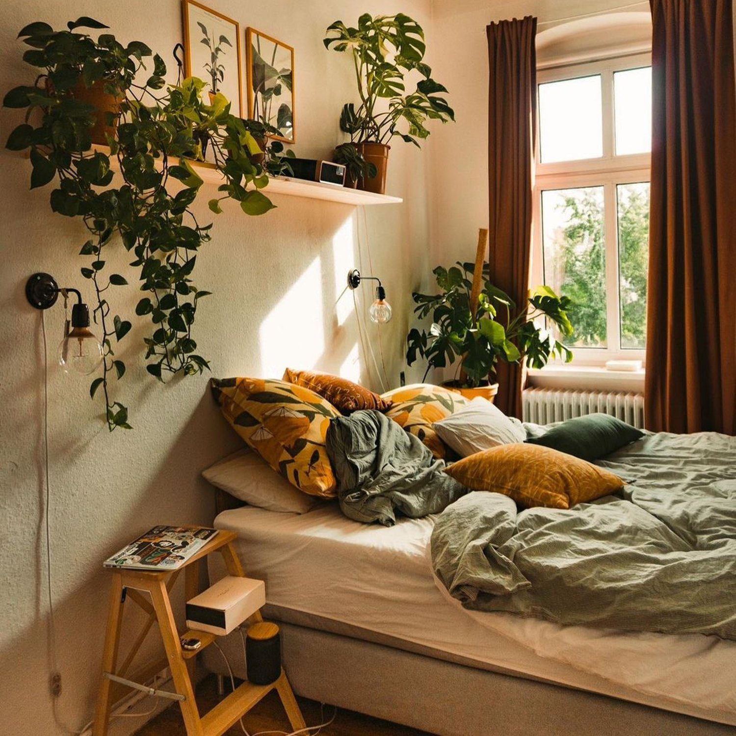 A cozy bedroom with an abundance of natural light and greenery