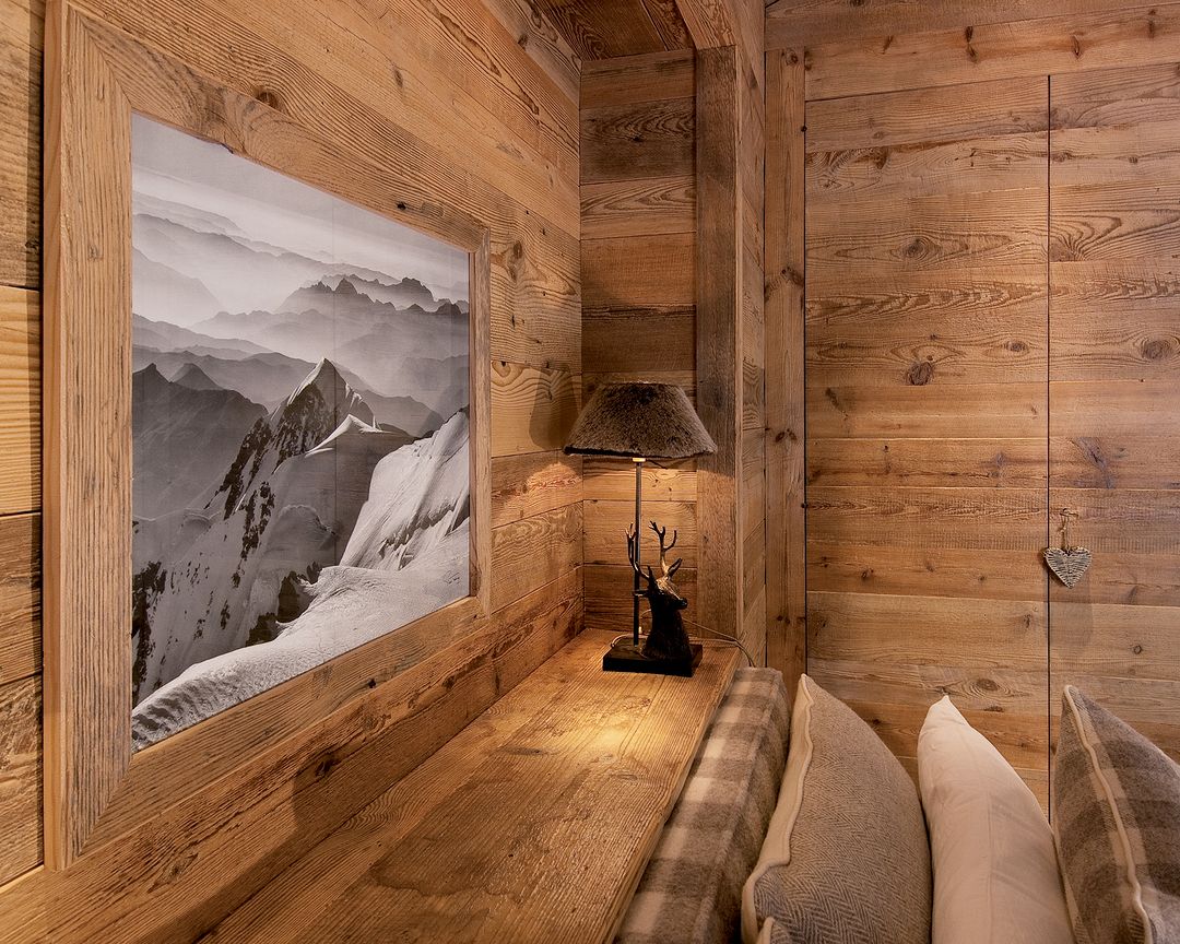 Cozy wooden cabin interior with mountain landscape artwork