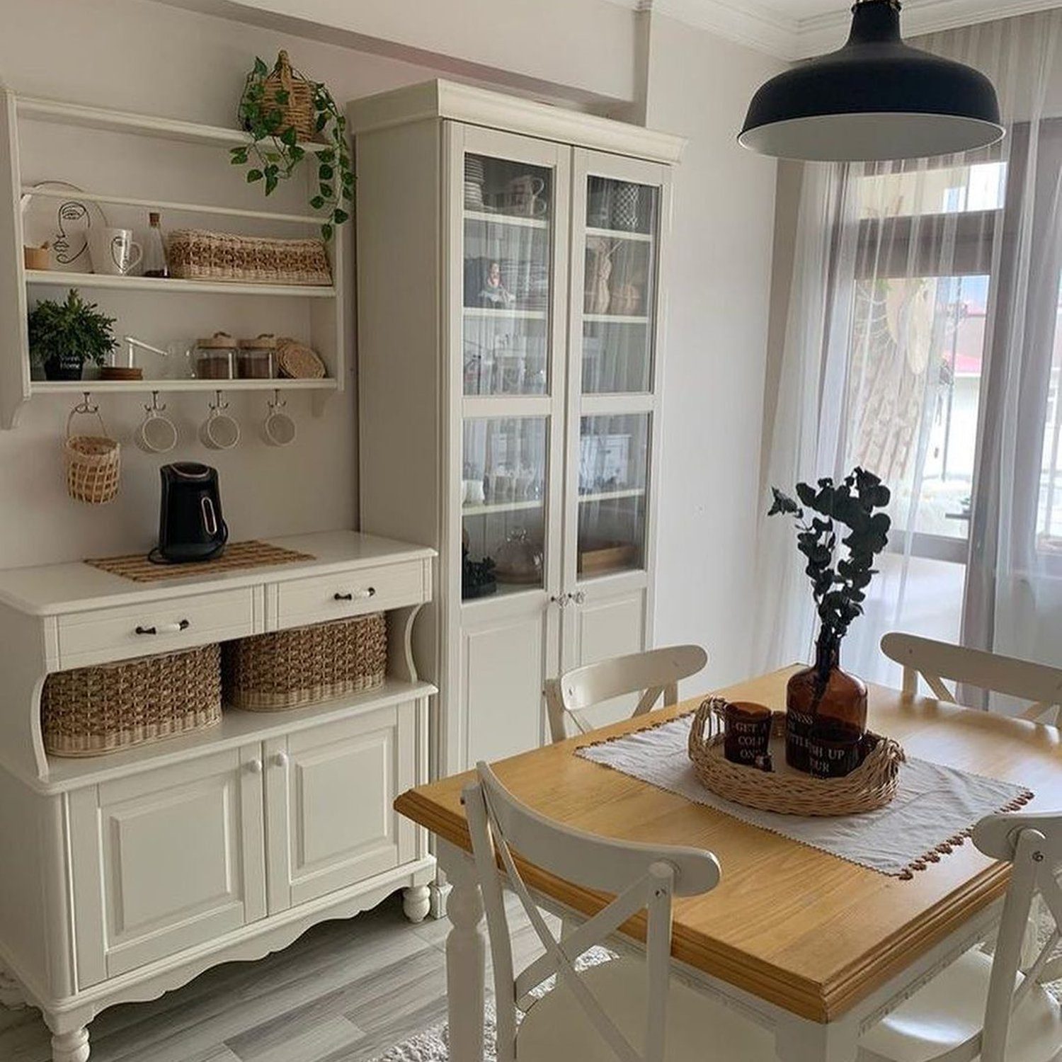 A cozy and inviting dining area with white furniture and natural wood accents