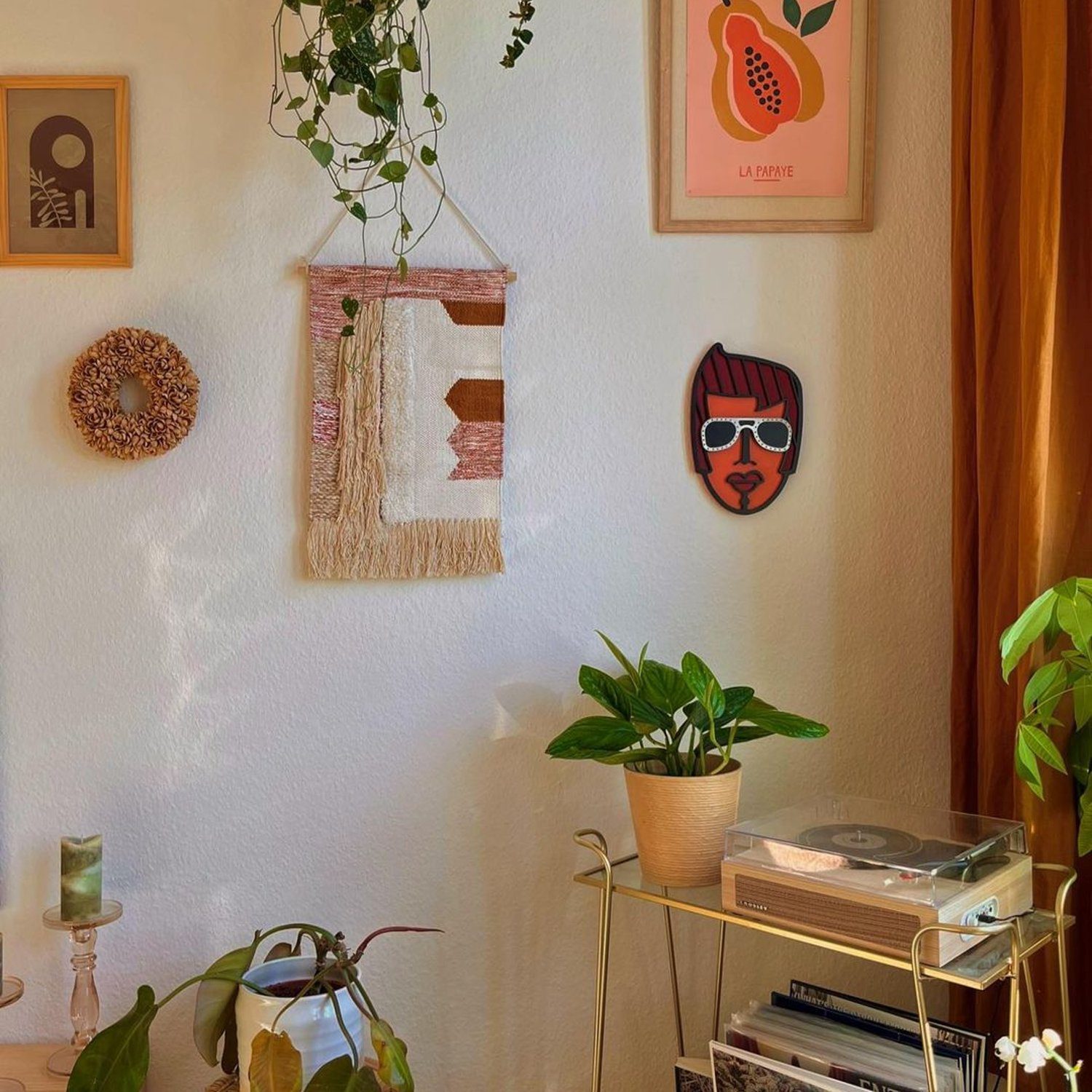 A cozy corner with houseplants and wall art