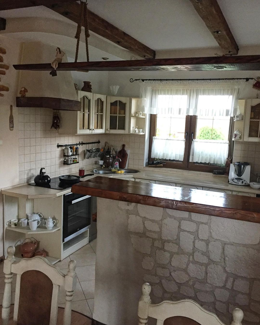 Cozy country-style kitchen with wooden beams and stone accents