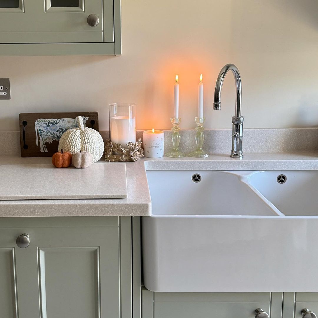 A cozy kitchen corner featuring a farmhouse-style sink and autumnal decor