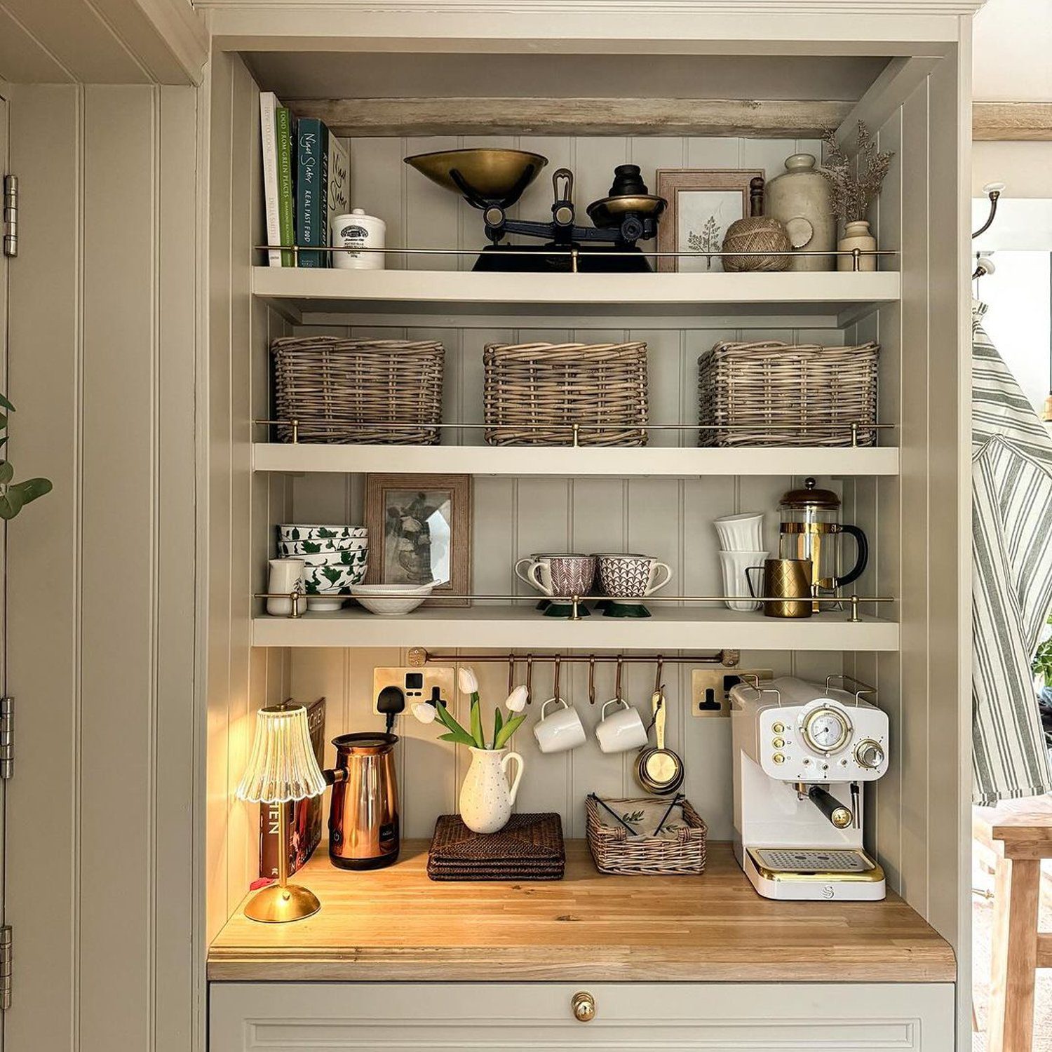 A cozy kitchen nook featuring an integrated shelving unit with rustic elements