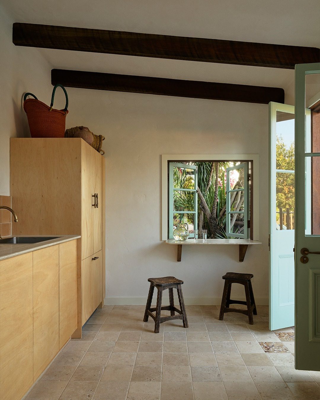 A serene kitchen corner featuring natural materials and a view to the lush outdoors