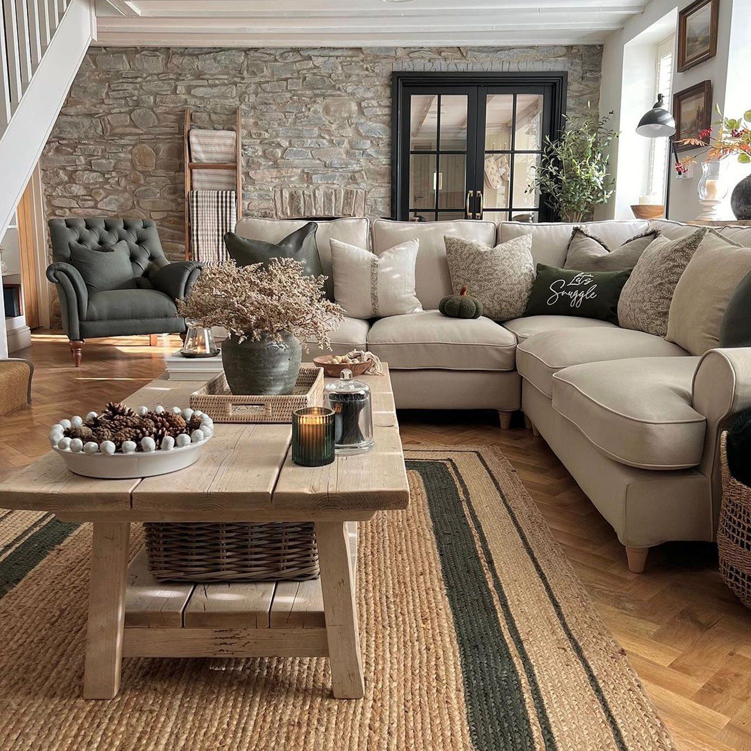 Cozy living room with stone wall and sectional sofa.