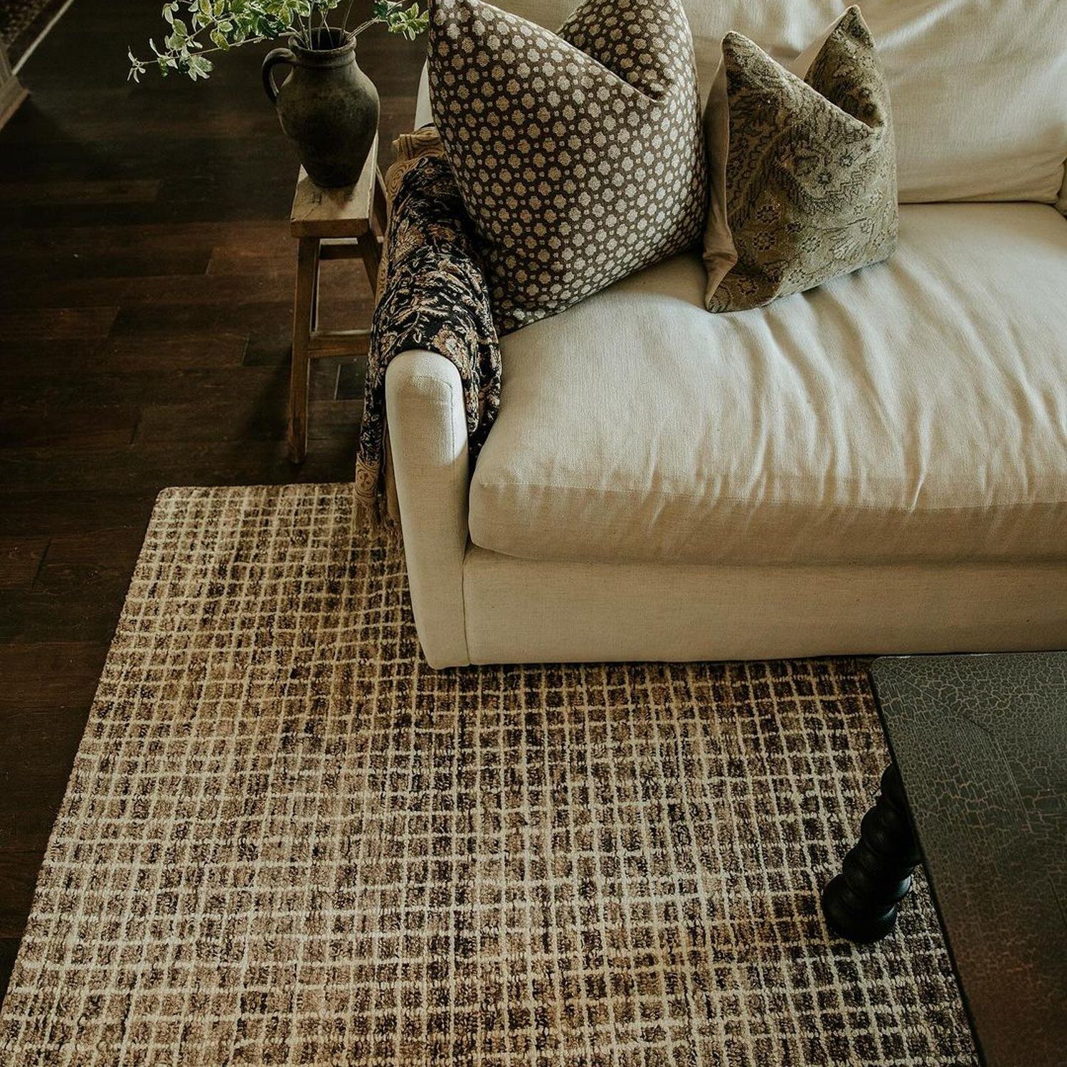 Cozy living room corner with a plush sofa and a vintage vibe